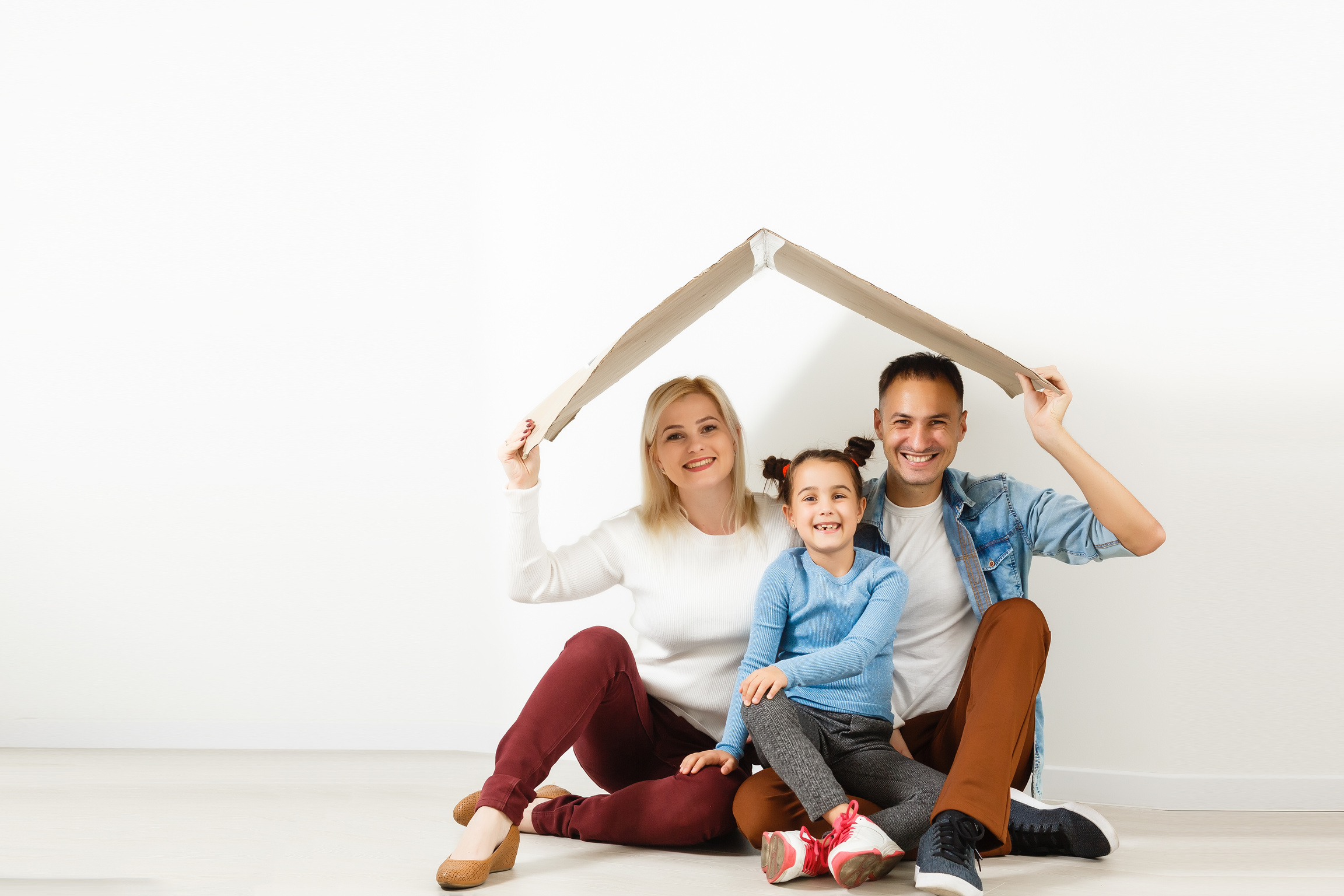 Happy young family under a safe roof, concept